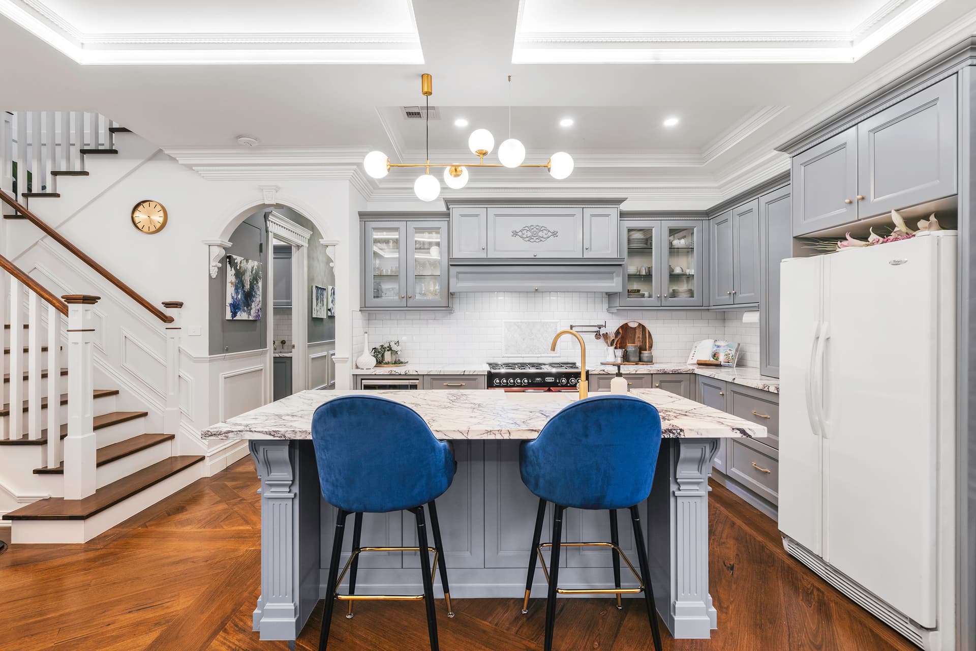 Custom kitchen with marble island and arch detail built by Katsaros Build
